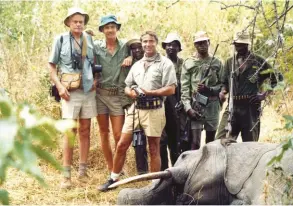  ??  ?? Brian (far left) with Bill Feldstein (holding the double rifle). The rifle is a 4-bore and was used to successful­ly bring down the tusker.