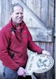  ??  ?? Ranger Andy Simmons, with a National Trust nameplate.