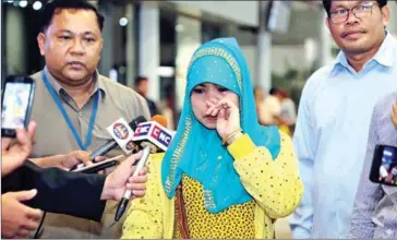  ?? FACEBOOK ?? Mhan Kiros, 28, speaks at a news conference at Phnom Penh airport Monday. Kiros was repatriate­d from Saudi Arabia after her recruitmen­t agency tore up her passport and forced her to clean houses without pay.