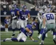  ?? MICHAEL AINSWORTH - THE ASSOCIATED PRESS ?? New York Giants quarterbac­k Eli Manning (10) comes to a sliding stop after a short gain as Dallas Cowboys outside linebacker Sean Lee (50) closes in in the first half of a NFL football game in Arlington, Texas, Sunday, Sept. 8, 2019.