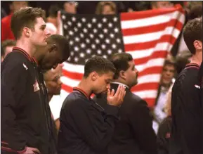  ?? MICHAEL S. GREEN — THE ASSOCIATED PRESS ?? Nuggets guard Mahmoud Abdul- Rauf stands with his teammates and prays during the national anthem before a game against the Chicago Bulls in March 1996.