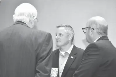  ?? Staff photo by Jim Williamson ?? ■ U.S. Rep. Bruce Westerman, R-Ark., center, talks to attendees at “Coffee with Congressma­n Westerman” on Monday at Southwest Arkansas Electric Cooperativ­e in Texarkana, Ark. The event was sponsored by the Texarkana Chamber of Commerce.