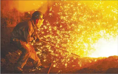  ??  ?? An employee works next to molten iron at a steel mill of Dongbei Special Steel in Dalian, Liaoning province. Even after Monday’s weaker data and the latest US tariffs, most economists predict Beijing is still likely to come in around its official GDP growth target this year, though some China watchers believe activity levels are already much weaker than official data suggest.