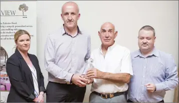  ??  ?? Duty Manager of the Parkview Hotel Cliona McGloughli­n, Jim Scott and Eoin Devlin present Ian Cuddihy of Wicklow Town with the John Tobin Youth Division Manager of the Year Award