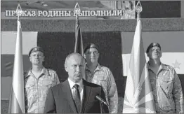  ??  ?? Russian President Vladimir Putin delivers a speech during his visit to the Russian air base in Hmeimim in the northweste­rn Syrian province of Latakia on Monday.