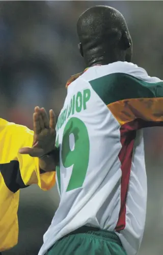  ?? Getty; Satish Kumar for The National ?? Ali Bujsaim refereeing the opening match of the 2002 World Cup between France and Senegal; the former Fifa official during the interview at his home in Dubai