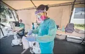  ?? Allen J. Schaben Los Angeles Times ?? NURSES Esteban Gomez, left, and Maritza Perez log patient informatio­n at a testing site in Anaheim.