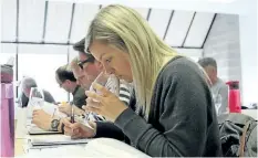  ?? TIFFANY MAYER/SPECIAL TO THE STANDARD ?? Students sniff, sample and take notes during an intensive cider business course offered by Brock University.