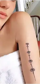  ??  ?? Toff tattoo: Frankie Herbert and her daisy chain motif