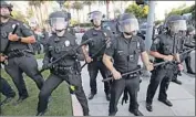  ?? BEVERLY HILLS Luis Sinco Los Angeles Times ?? police stand between supporters and foes of President Trump in September 2019.