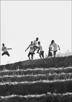  ?? — AFP photos ?? Nepali Buddhist monks running during a training session in Sindhukot village, some 80 kilometres northeast of Kathmandu.