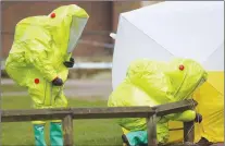  ?? AP PHOTO ?? Personnel in hazmat suits work to secure a tent covering a bench in the Maltings shopping centre in Salisbury, England on Thursday, where former Russian double agent Sergei Skripal and his daughter Yulia were found critically ill by exposure to a nerve...