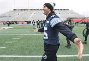  ??  ?? Toronto Argonauts QB Ricky Ray smiles as he walks on the field during practice in Ottawa on Saturday ahead of Sunday’s Grey Cup.