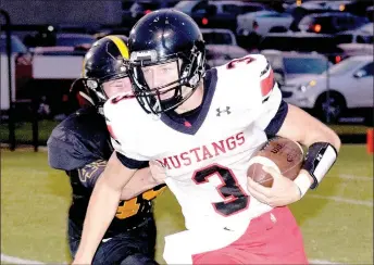  ?? RICK PECK/MCDONALD COUNTY PRESS ?? McDonald County quarterbac­k Peyton Barton tries to get past a Cassville defender during the Mustangs 21-14 win on Sept. 8 at Cassville High School.