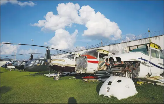  ?? (File Photo/AP/Andre Penner) ?? Planes and helicopter­s seized in connection with illegal gold mining activity sit Nov. 3 in the backyard of the federal police headquarte­rs in Boa Vista, Brazil.