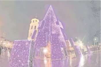  ?? — AFP photos ?? An illuminate­d Christmas tree is seen near the cathedral in Vilnius.