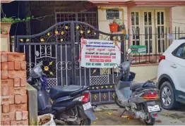  ?? — PTI ?? A poster stating containmen­t zone at the residence of a 46-year-old doctor who was detected with the Omicron variant of Covid-19 in Bengaluru on Friday.