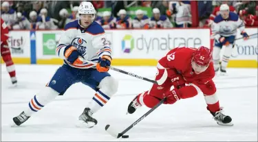  ?? PAUL SANCYA — THE ASSOCIATED PRESS ?? Detroit Red Wings’ Jonatan Berggren, right, tries to control the puck as Edmonton Oilers center Klim Kostin defends during the first period of Tuesday’s game in Detroit. The Red Wings dropped a 5-2decision to the Oilers.