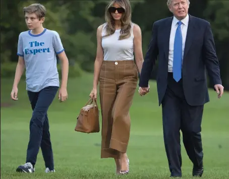  ??  ?? Moving in at last: First Lady Melania Trump and son Barron, 11, at the White House with Mr Trump