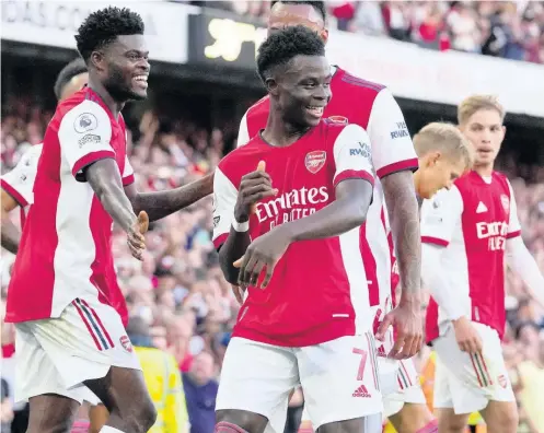  ?? AP ?? Arsenal’s Bukayo Saka (centre) celebrates after scoring his side’s third goal during the English Premier League match between Arsenal and Tottenham Hotspur at the Emirates stadium in London yesterday. Arsenal won 3-1.