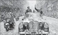  ?? AP PHOTO ?? ABOVE LEFT: In this June 29, 1962 file photo, U.S. President John F. Kennedy and Mexican President Adolfo Lopez Mateos are showered with confetti and paper as they travel down a boulevard in Mexico City, shortly after Kennedy’s arrival for a three-day...