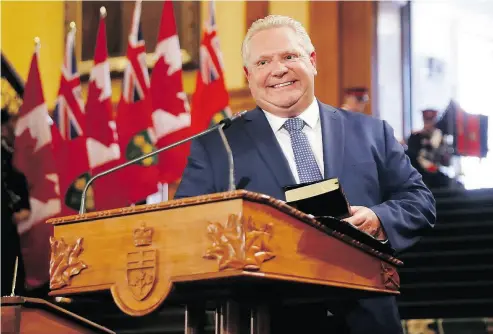  ?? MARK BLINCH / THE CANADIAN PRESS ?? Doug Ford is sworn in as premier of Ontario during a ceremony at Queen’s Park in Toronto on Friday.