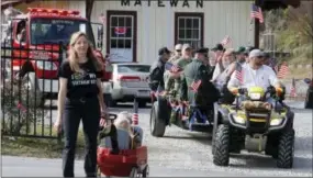  ?? THE ASSOCIATED PRESS ?? A wagon load of veterans are driven through town Nov. 11 during the Veterans Day parade in Matewan, W.Va.