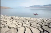  ?? ETHAN SWOPE — THE ASSOCIATED PRESS ?? A kayaker paddles in Lake Oroville as water levels remain low due to continuing drought conditions.