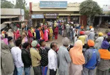  ?? AFP ?? Villagers in Khasa, Amritsar, queue at a bank as demonetisa­tion took effect last year. Bitcoin is India’s latest big step