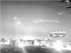  ?? — Reuters photo ?? Missiles fire is seen over Damascus, Syria in this handout photo.