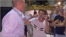  ?? The Associate Press ?? In this image made from video, Senator Fraser Anning swipes at a teenager who broke an egg on his head while he was holding a press conference, Saturday in Melbourne.