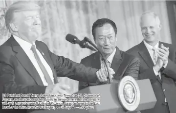  ??  ?? US President Donald Trump shakes hands with Terry Gou (C), Chairman of Foxconn, an electronic­s supplier, during an announceme­nt that the company will open a manufactur­ing facility in Wisconsin, during an event in the East Room of the White House in...