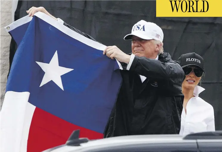  ?? EVAN VUCCI / THE ASSOCIATED PRESS ?? President Donald Trump, with first lady Melania, holds up a Texas flag after meeting supporters in Corpus Christi on Tuesday. his first visit to the state since the storm hit.