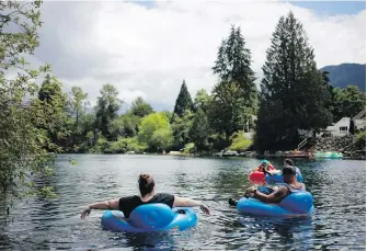  ?? CHAD HIPOLITO, VIA VANCOUVER SUN ?? Tubers float on the Cowichan River in July 2018.