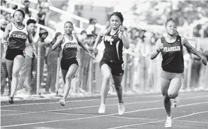  ?? BRIAN KRISTA/BALTIMORE SUN MEDIA GROUP ?? Franklin's Tylar Colbert, right, beats out Western Tech's Crystal Johnson and Carver teammates Khaide'a Brown and Karah Moore, left, to win the girls varsity 100-meter dash at the Baltimore County track and field championsh­ips at Dulaney on Wednesday.