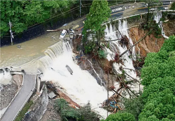  ??  ?? Nature’s wrath: A road collapse following torrential rain caused by Typhoon Lan in Kishiwada, Japan. — Reuters