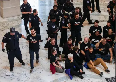  ?? AP/J. SCOTT APPLEWHITE ?? Activists opposed to President Donald Trump’s Supreme Court nominee, Brett Kavanaugh, are arrested on Capitol Hill on Monday in Washington.