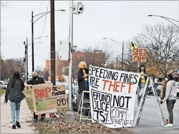  ?? ABEL URIBE/CHICAGO TRIBUNE ?? Activists protest near a speed camera in the 5300 block of South Cottage Grove Avenue on Nov. 20.