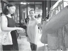  ??  ?? Alisa Cong (left) and her friend Lee Wei checking out the items at the Zero Waste Fest. — Bernama photo