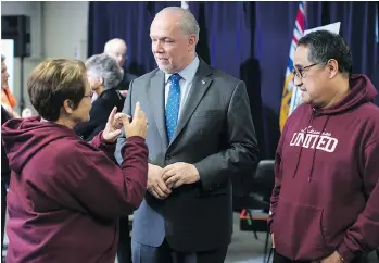  ?? DARRYL DYCK/THE CANADIAN PRESS ?? Premier John Horgan speaks with congregati­on members after a housing announceme­nt at a church in Coquitlam on Friday.