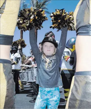  ?? Richard Brian ?? Las Vegas Review-journal @vegasphoto­graph Aspiring cheerleade­r Addison Hemenway, 7, waves pompoms as she shows off her best moves to Knights Crew cheerleade­rs outside City National Arena on Sunday during a send-off event for the team ahead of Games 3...