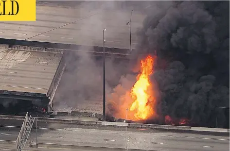  ?? WSB-TV VIA THE ASSOCIATED PRESS ?? A large fire that caused an overpass on Interstate 85 to collapse burns in Atlanta on Thursday. No one was hurt, but the incident poses a massive transporta­tion crisis as the I-85 carries 250,000 cars a day through the city and is a key north-south...