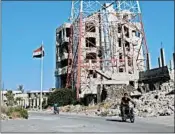  ?? MOHAMAD ABAZEED/GETTY-AFP ?? The Syrian government raised its flag Thursday over Daraa, the first city to revolt against President Bashar Assad.