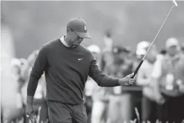  ?? (AP) ?? TIGER Woods looks so disappoint­ed after a bogey-bogey finish for a 72, leaving him 9 shots off Gary Woodland halfway through the US Open.