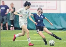  ?? BOB TYMCZYSZYN
THE ST. CATHARINES STANDARD ?? Annie Ibey from St. Michael makes a pass under pressure from Kate Raso from Notre Dame during the Niagara College Knights Niagara Region soccer showcase game at Youngs Sportsplex in Welland Wednesday.