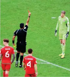  ?? ANI ?? Wales keeper Wayne Hennessey is being shown the red card during the match against Iran.