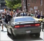  ?? THE DAILY PROGRESS VIA AP ?? A vehicle drives into a group of protesters demonstrat­ing against a white nationalis­t rally in Charlottes­ville, Va., Saturday.