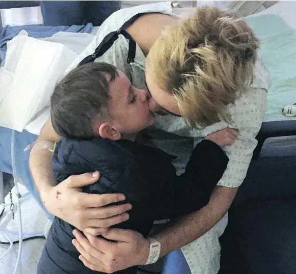  ?? PHOTO COURTESY JASON KEATING ?? Brayden Camrud, a member of the Humboldt Broncos who survived Friday’s horrific crash, gets a hug from his cousin, Jaxson Keating, on Monday at Royal University Hospital in Saskatoon. Jaxson survived after being born 15 weeks early and is regarded as a...