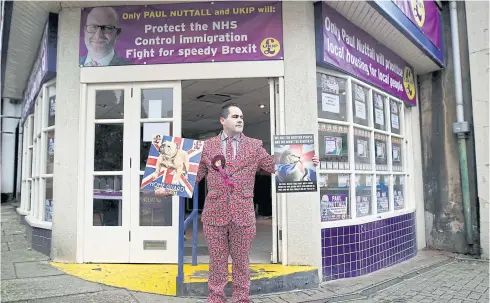  ??  ?? PATRIOT GAME: A Ukip supporter dressed in a Union Jack flag suit stands outside the party’s by-election campaign office in Stoke-on-Trent, England.