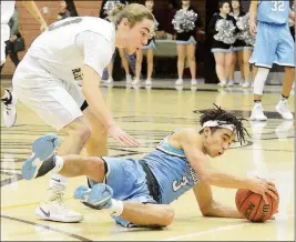  ??  ?? ABOVE: GILA RIDGE’S ANTHONY RODRIGUEZ (3) HITS THE FLOOR while pursuing a loose ball during the second quarter of Tuesday night’s game against Cibola at Raider Gym. Also in on the play is Cibola’s Ryan Curtis-Sanchez. RIGHT: Gila Ridge’s Johnny Kay...